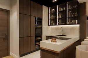 modern, trendy small bar area with lights in cabinet shelving JM Kitchen & Bath Design