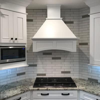 white stove hood with italian subway tile JM Kitchen & Bath Design