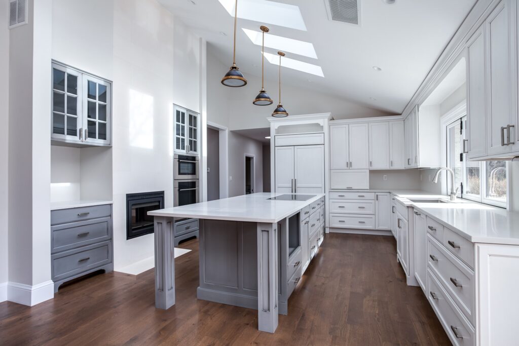 White painted kitchen cabinets with light grey painted island