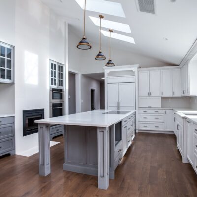 White painted kitchen cabinets with light grey painted island JM Kitchen & Bath Design