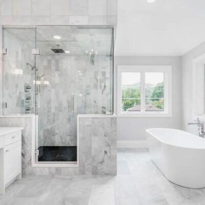 bathroom design remodel includes large tub with white vanity and light gray floors JM Kitchen & Bath Design